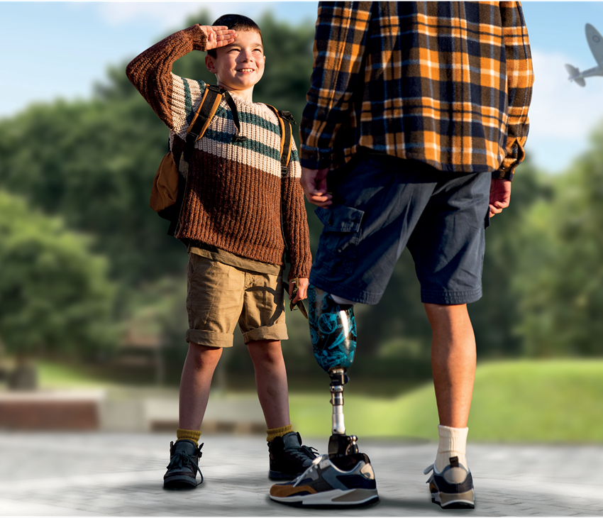 A young boy saluting a soldier with a prosthetic leg